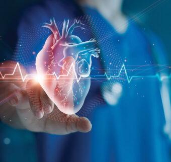 A nurse reaches out to touch an illustrated virtual reality heart monitor.