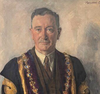 A close up of a painting of Edward in his RCSI dress robes by Margaret Clarke.